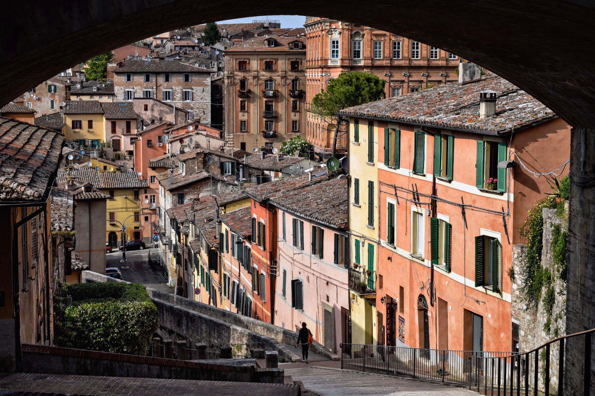 Colourful houses seen through an arch in Perugia