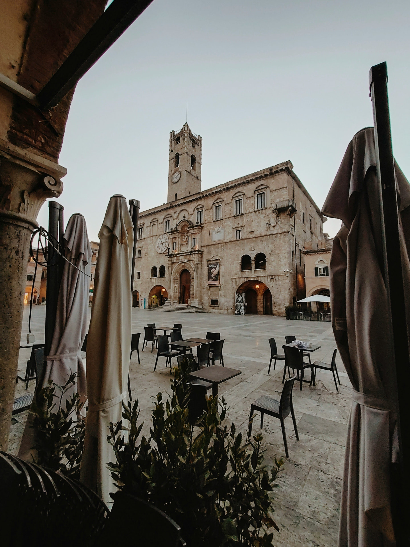 Piazza del Popolo in Ascoli Piceno, seen between the café umbrellas