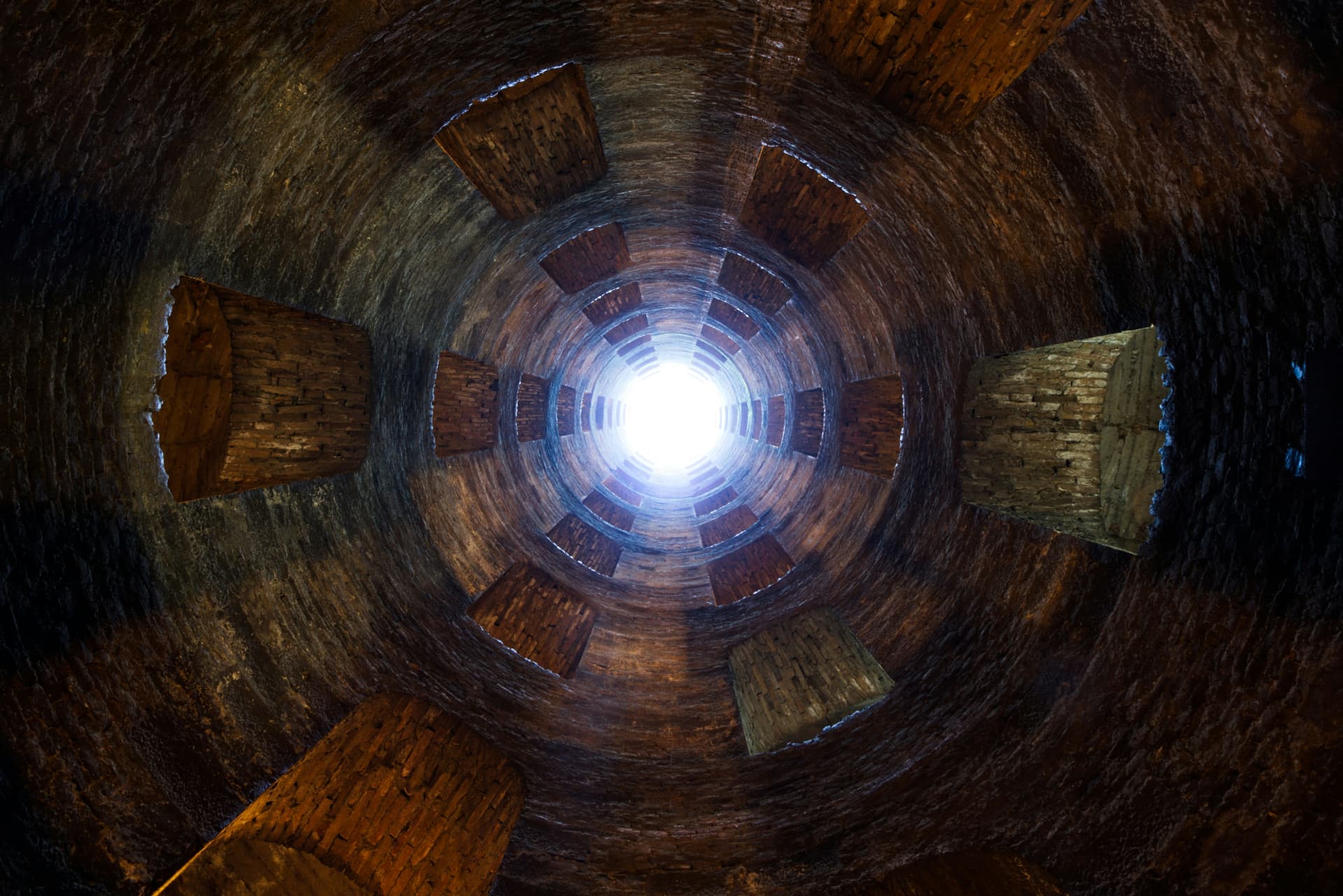 Inside the Pozzo di San Patrizio: the spiral ramps and a ring of windows climbing toward daylight