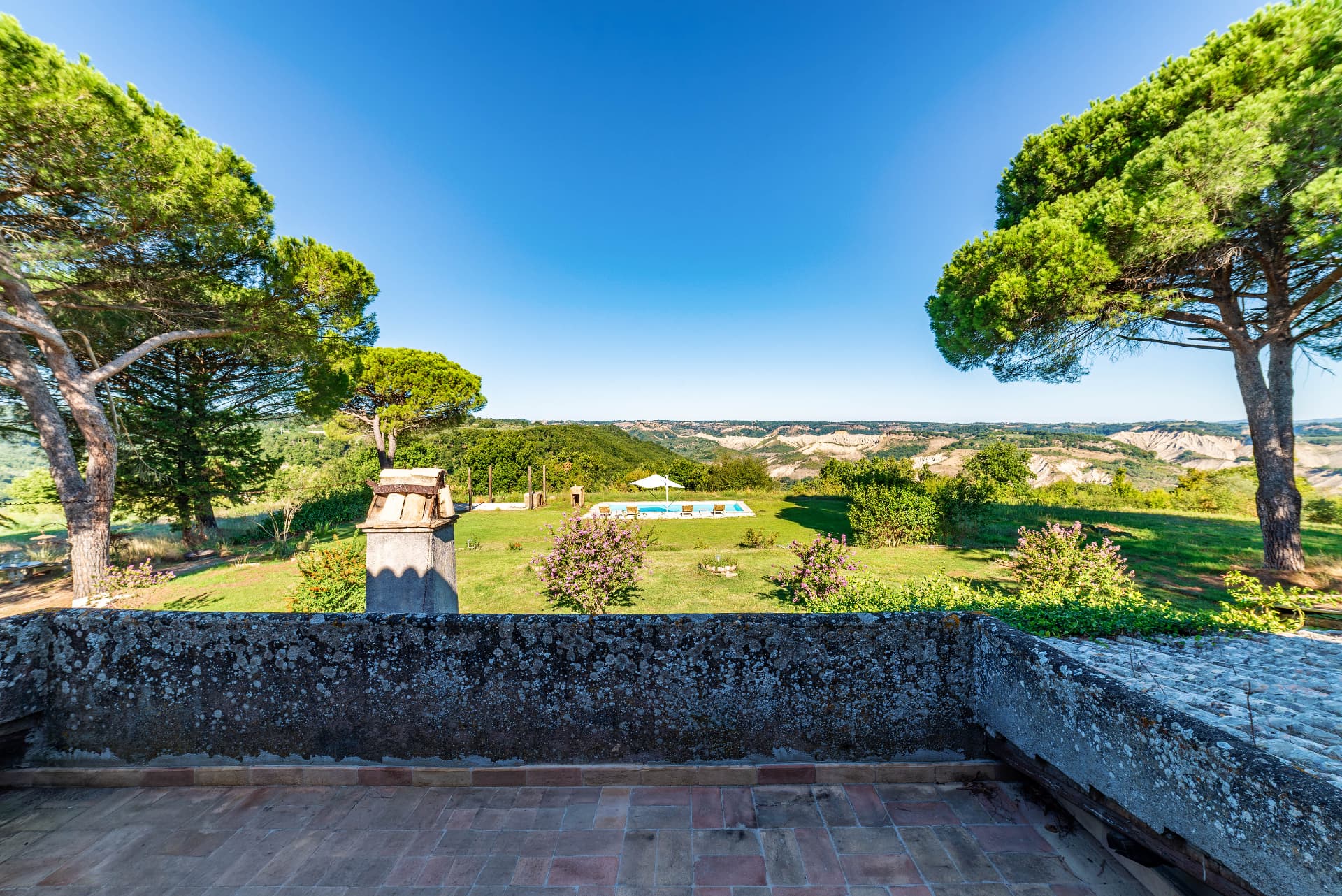 The terrace, garden and pool looking over the calanchi