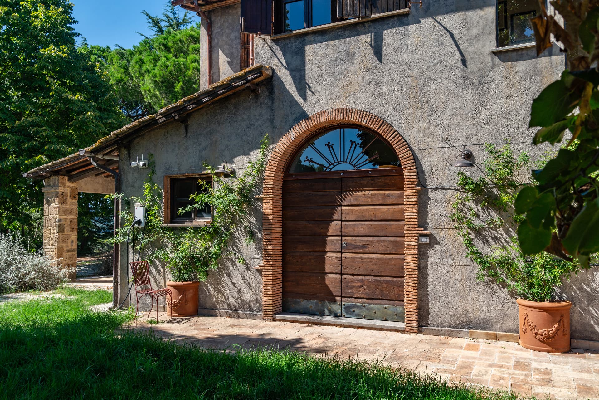 The old arched barn door at the back of the house, brick and wood
