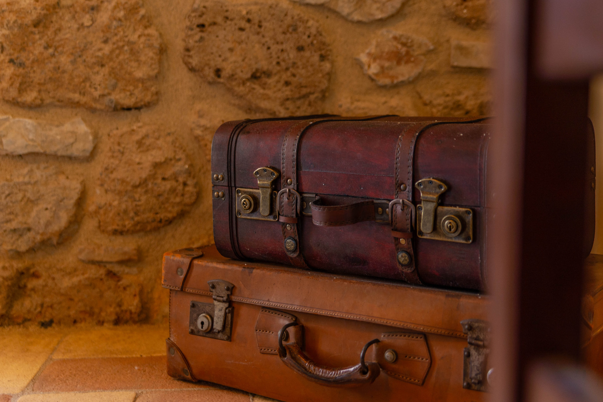 Vintage leather suitcases against the stone wall
