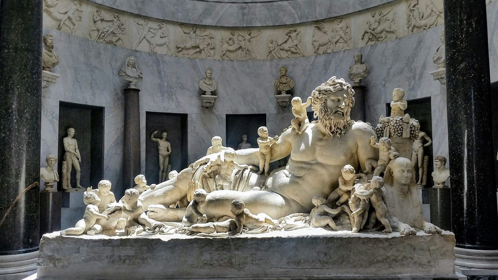 The ancient marble Nile river god surrounded by playful putti