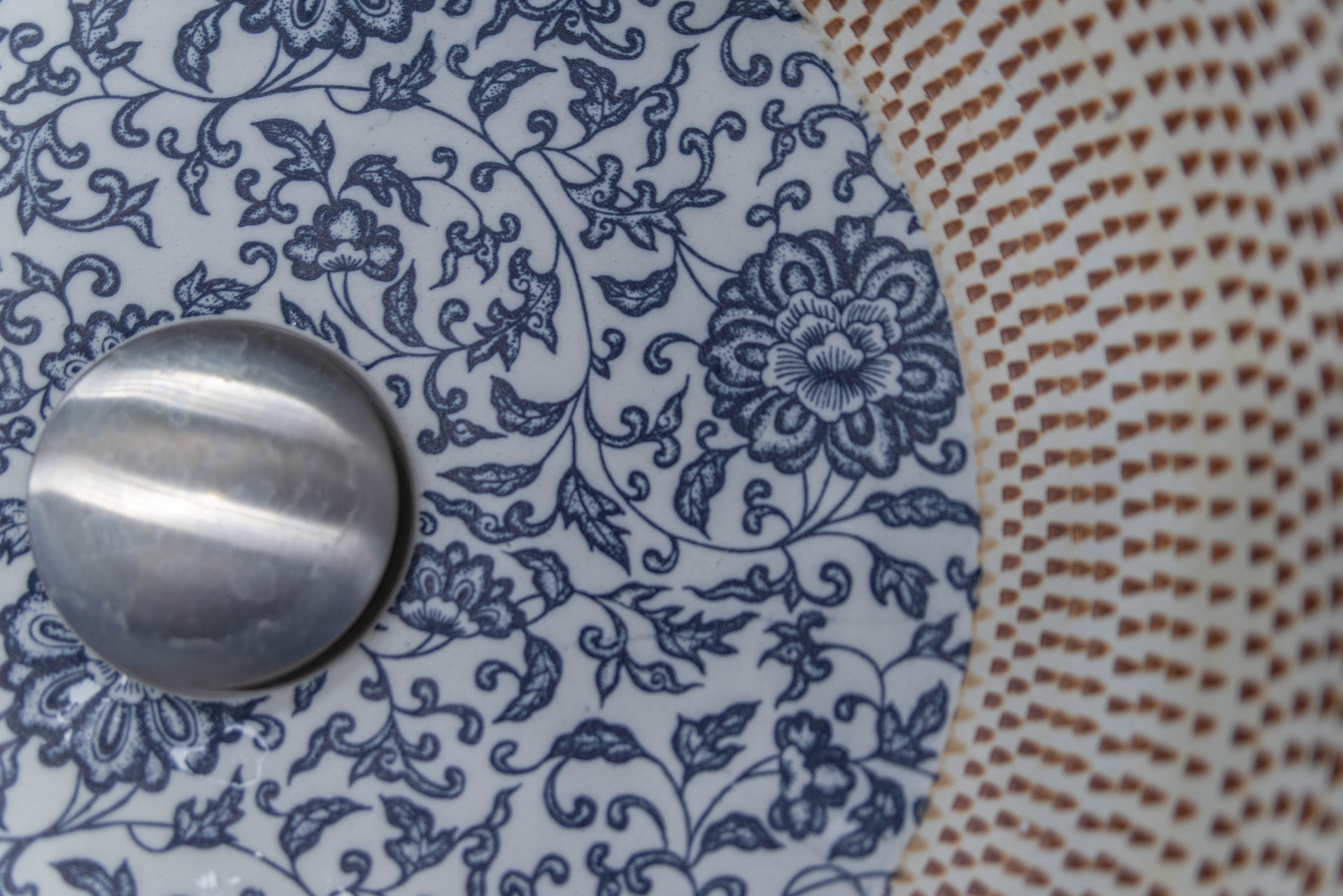Blue floral decoration on a ceramic washbasin