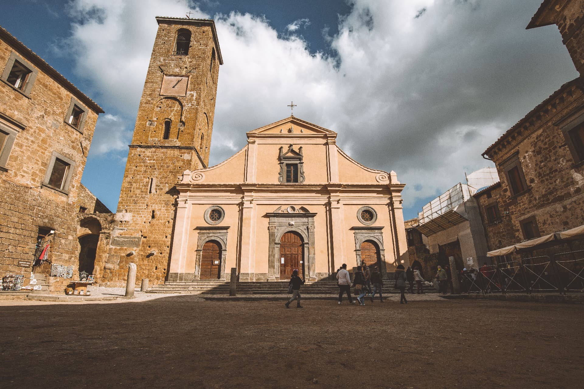 Piazza San Donato in Civita, the church façade and the tufa bell tower under breaking cloud