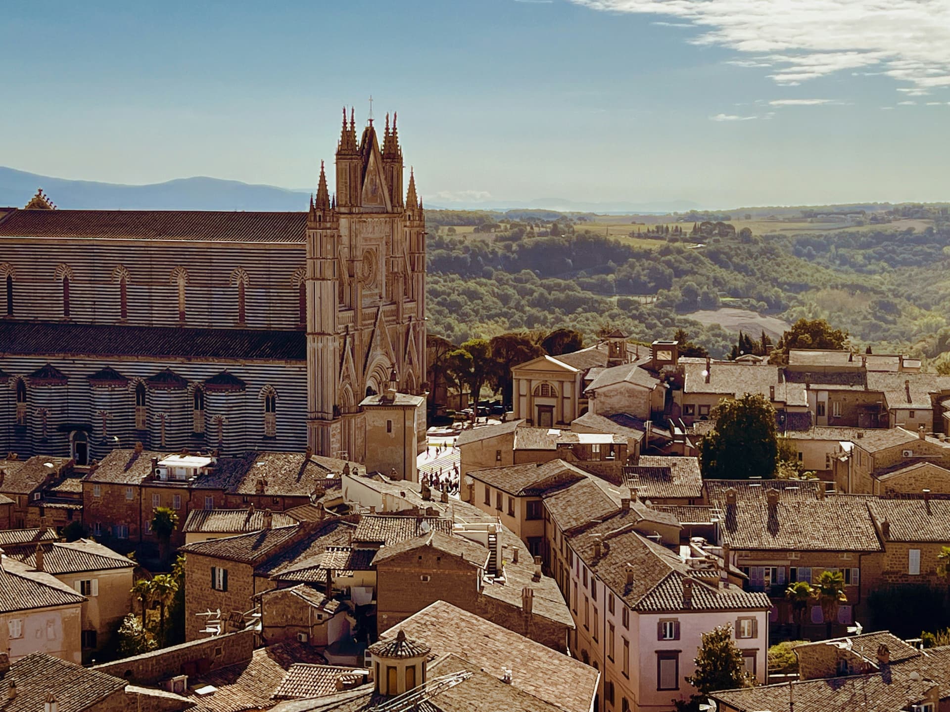 The rooftops of Orvieto and the banded flank of the Duomo above the Umbrian hills