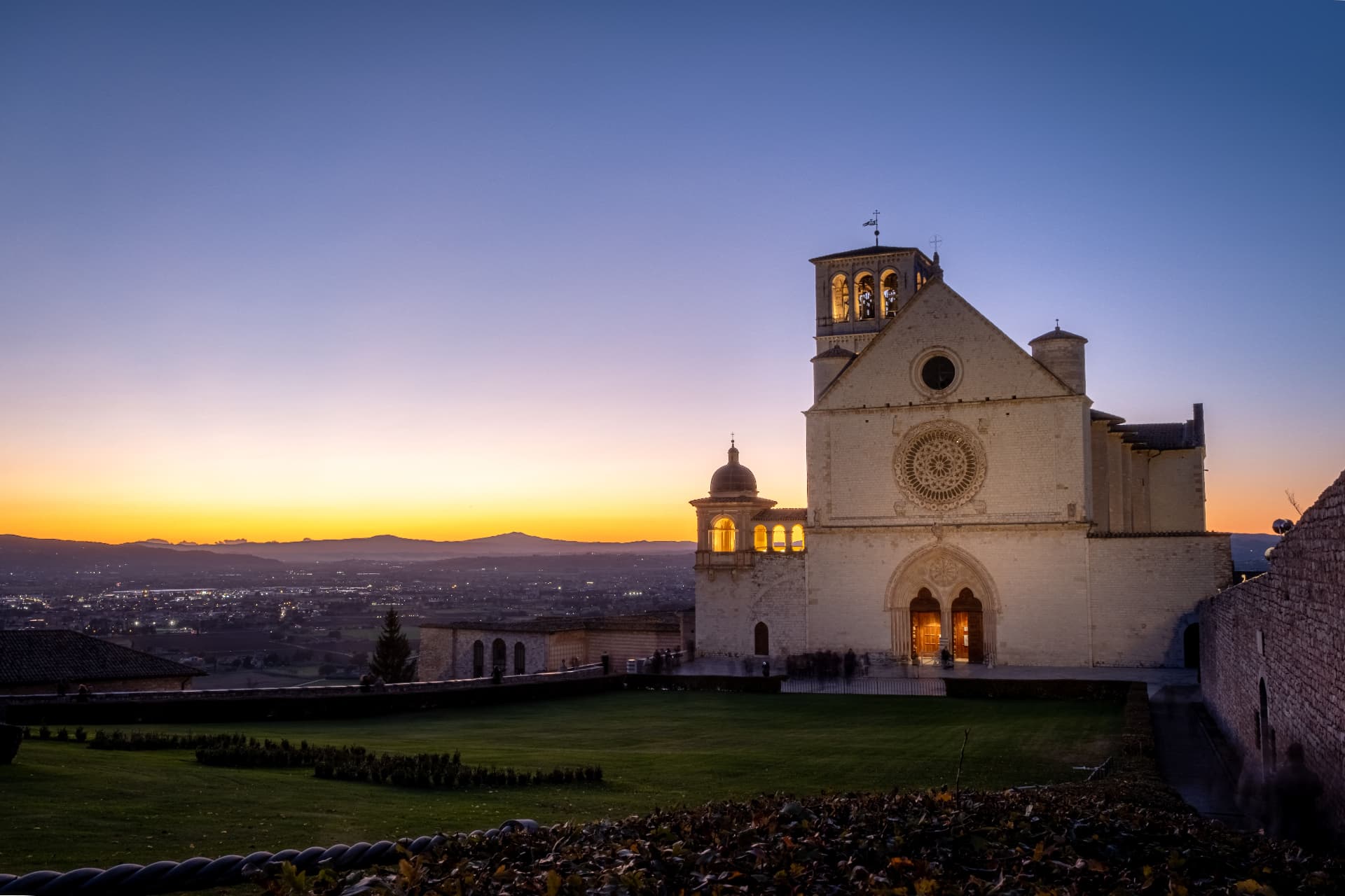 The Basilica of San Francesco at dusk over the valley