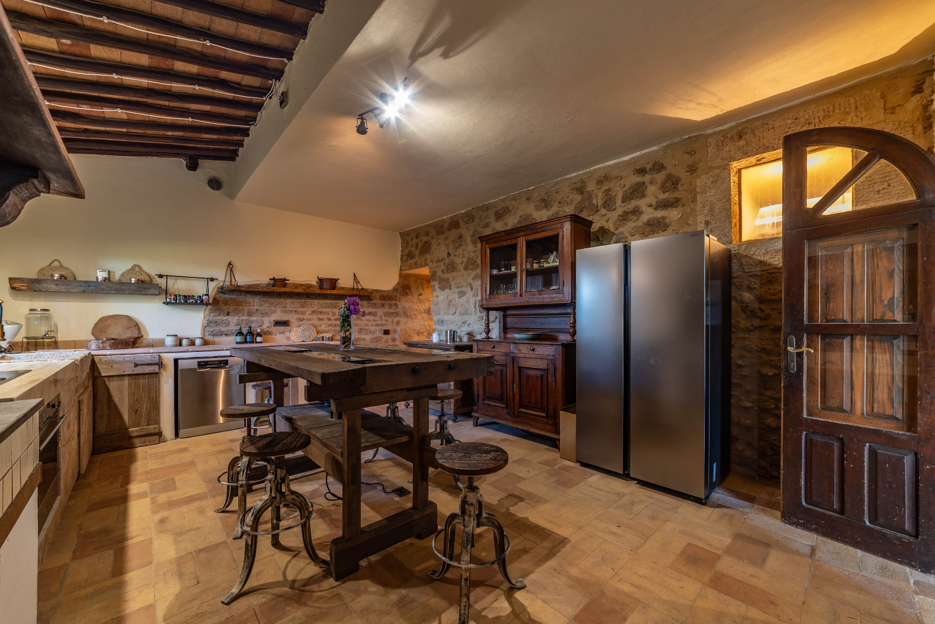 The kitchen built around an old carpenter's workbench, under the original wooden beams