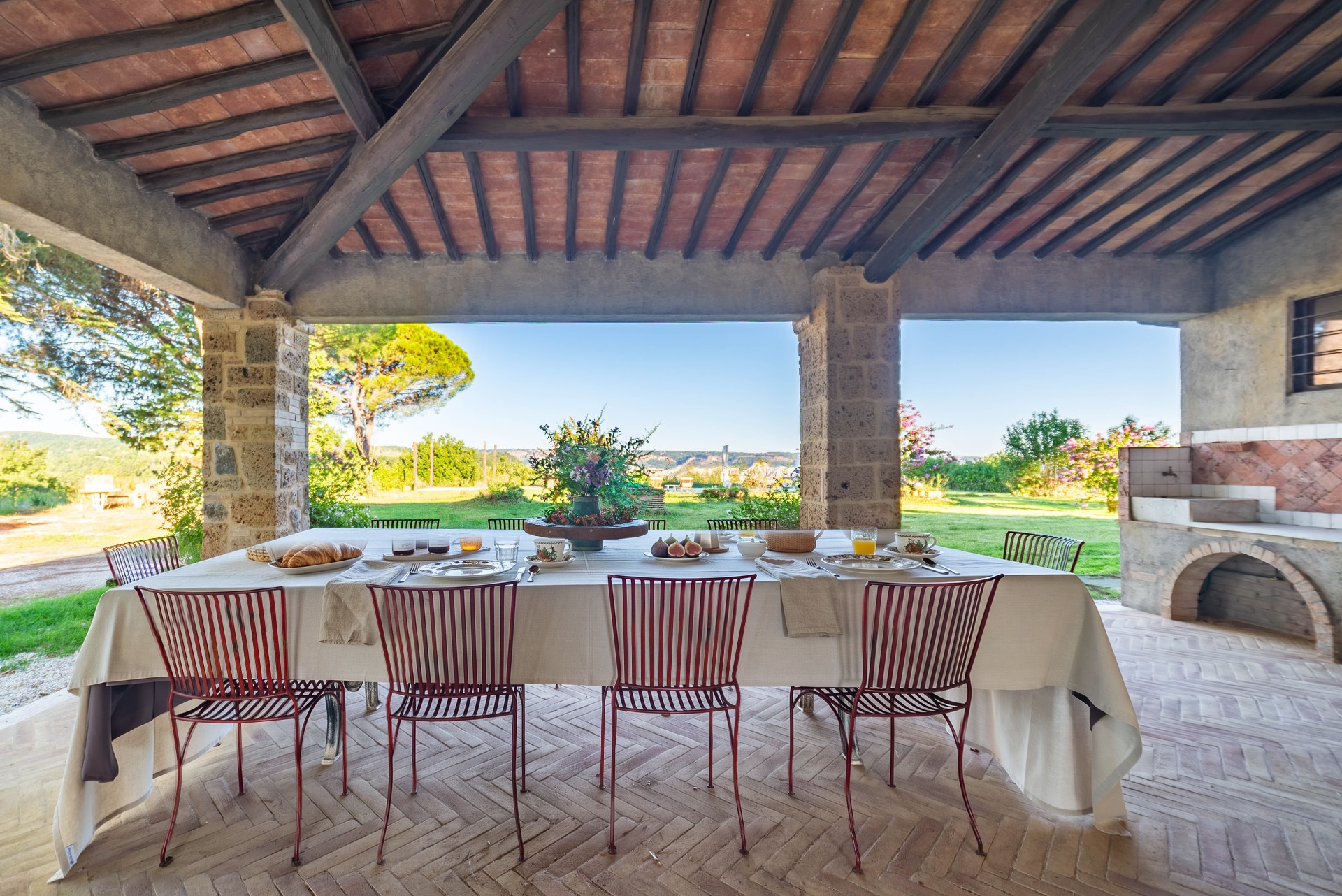 The breakfast table under the portico, with the garden beyond