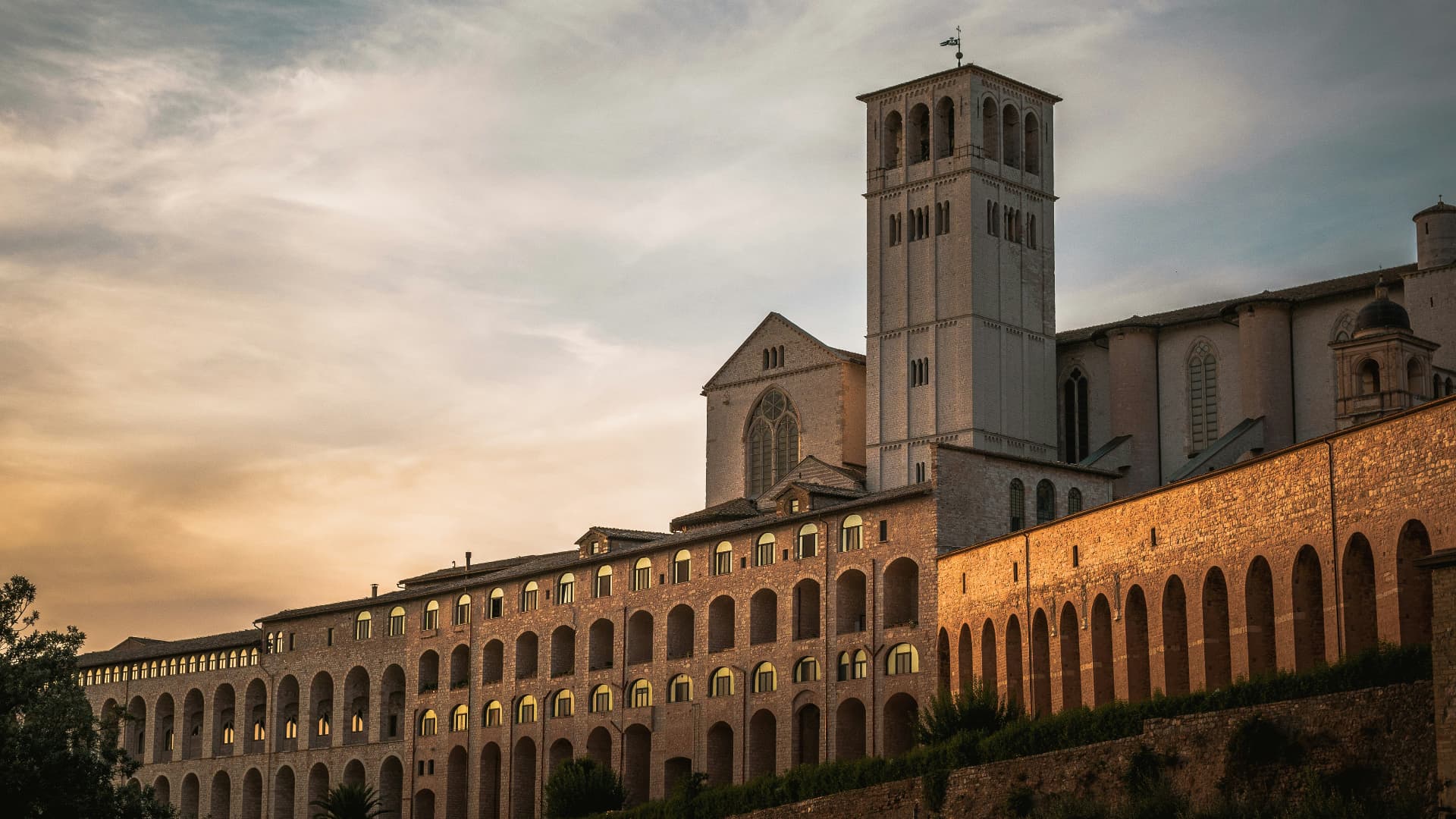 The long arcaded wall of the Basilica at golden hour