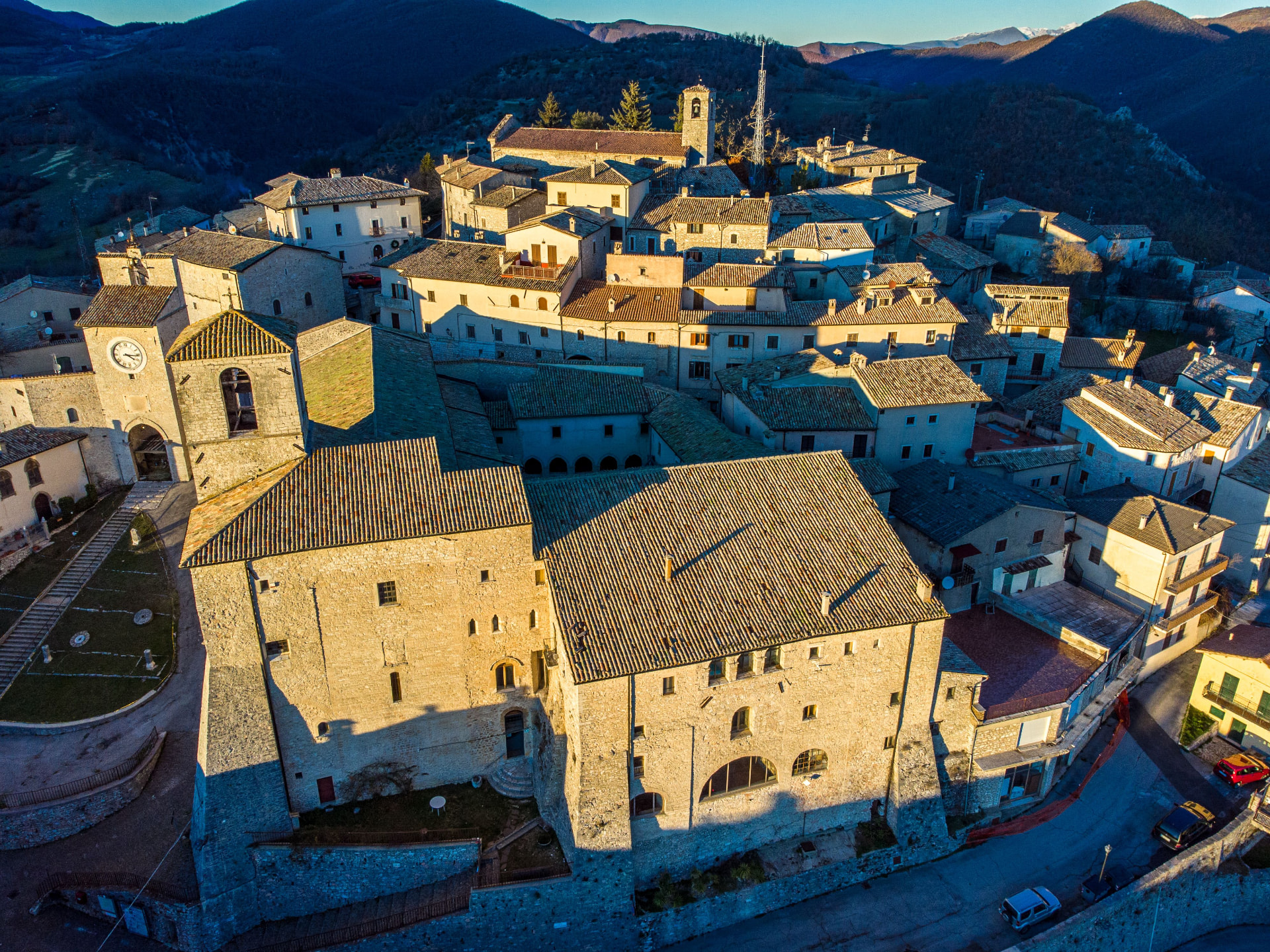 A stone hill town seen from the air at dawn