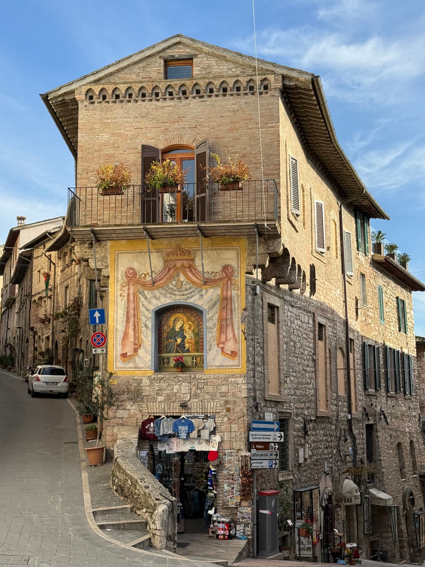 A medieval stone house with a painted Madonna in Assisi